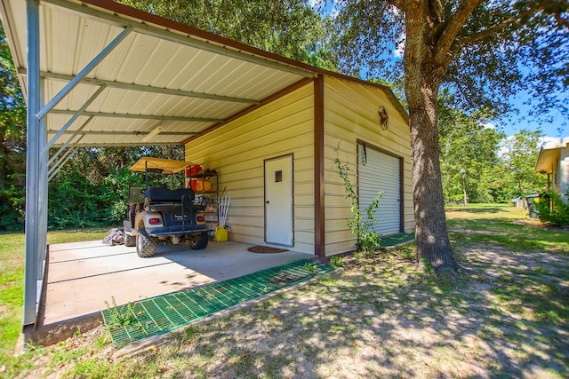 view of outbuilding featuring a garage and a carport