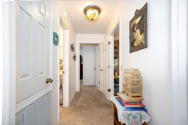 hallway featuring light carpet