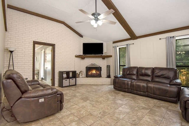 living room featuring lofted ceiling with beams, ceiling fan, a fireplace, and brick wall