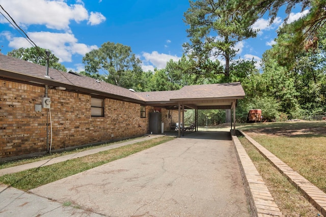 exterior space with a front lawn and a carport