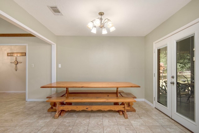 dining space with french doors, light tile patterned flooring, and an inviting chandelier