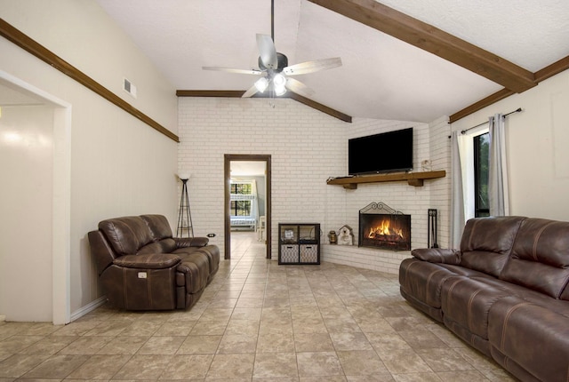 living room featuring vaulted ceiling with beams, ceiling fan, a fireplace, and brick wall