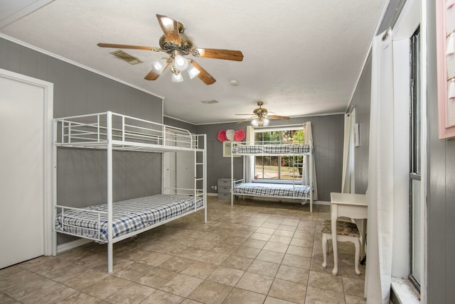 unfurnished bedroom featuring ceiling fan, ornamental molding, and a textured ceiling