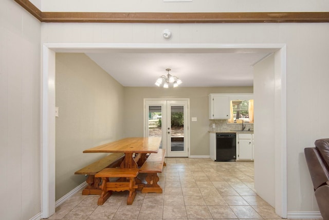 tiled dining area with wooden walls, french doors, sink, and an inviting chandelier