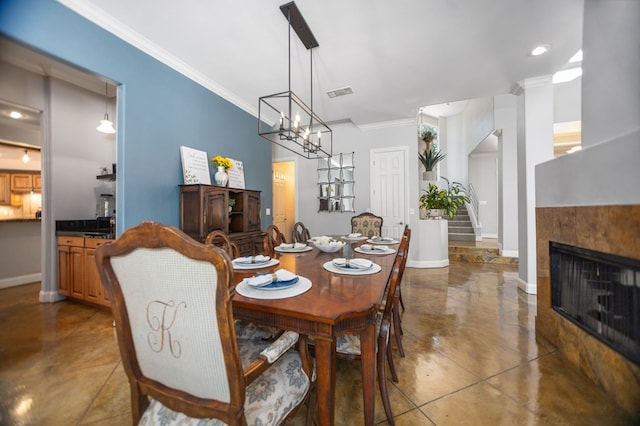 205 Twin Crk, Lufkin, TX 75904 - dining space featuring crown molding, baseboards, a tile fireplace, stairs, and a chandelier