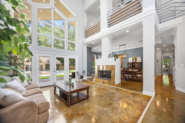 205 Twin Crk, Lufkin, TX 75904 - living room featuring a high ceiling, french doors, a premium fireplace, baseboards, and a chandelier