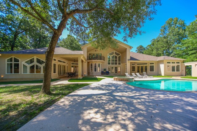 205 Twin Crk, Lufkin, TX 75904 - view of pool featuring a patio, a pool with connected hot tub, a ceiling fan, and french doors
