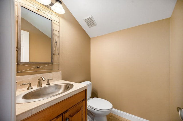 205 Twin Crk, Lufkin, TX 75904 - bathroom featuring toilet, vanity, tile patterned floors, vaulted ceiling, and baseboards