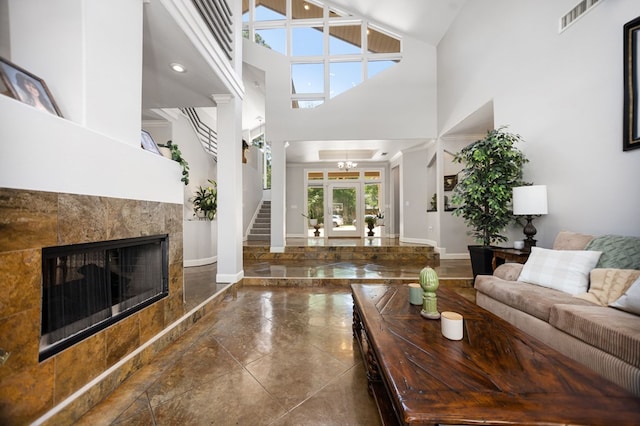 205 Twin Crk, Lufkin, TX 75904 - living room with a high ceiling, stairway, a premium fireplace, and baseboards