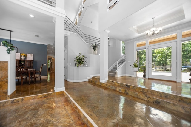 205 Twin Crk, Lufkin, TX 75904 - entrance foyer with ornamental molding, ornate columns, stairway, baseboards, and a chandelier