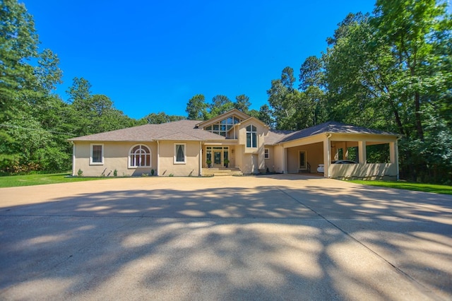 205 Twin Crk, Lufkin, TX 75904 - split level home with driveway, stucco siding, and a carport