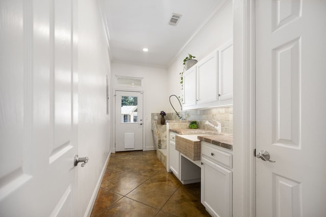 205 Twin Crk, Lufkin, TX 75904 - laundry area with ornamental molding, baseboards, and dark tile patterned flooring