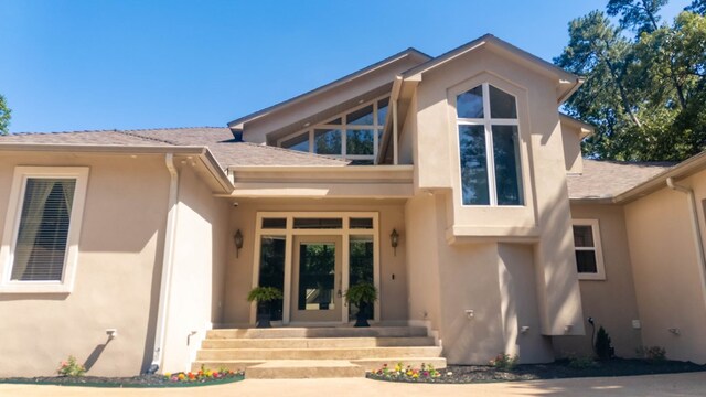 205 Twin Crk, Lufkin, TX 75904 - entrance to property featuring stucco siding and a shingled roof