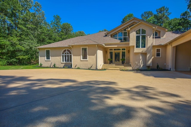 205 Twin Crk, Lufkin, TX 75904 - view of front of property with stucco siding, roof with shingles, and concrete driveway