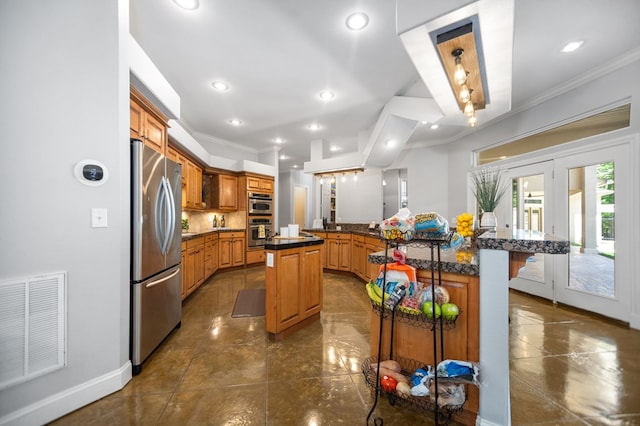 205 Twin Crk, Lufkin, TX 75904 - kitchen with appliances with stainless steel finishes, a breakfast bar area, ornamental molding, a large island with sink, and dark countertops