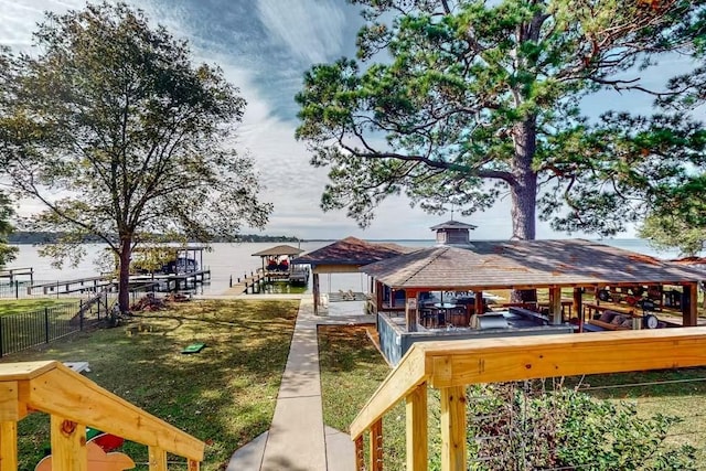 dock area with a yard, fence, and a gazebo