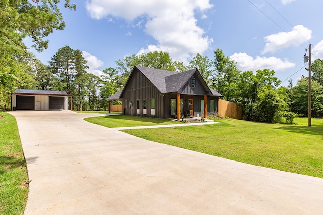 190 Whitehead Dr, Diboll, TX 75941 - view of front of property with an outdoor structure, a front yard, a detached garage, and board and batten siding