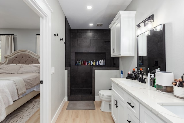 190 Whitehead Dr, Diboll, TX 75941 - ensuite bathroom featuring wood finished floors, double vanity, walk in shower, toilet, and recessed lighting