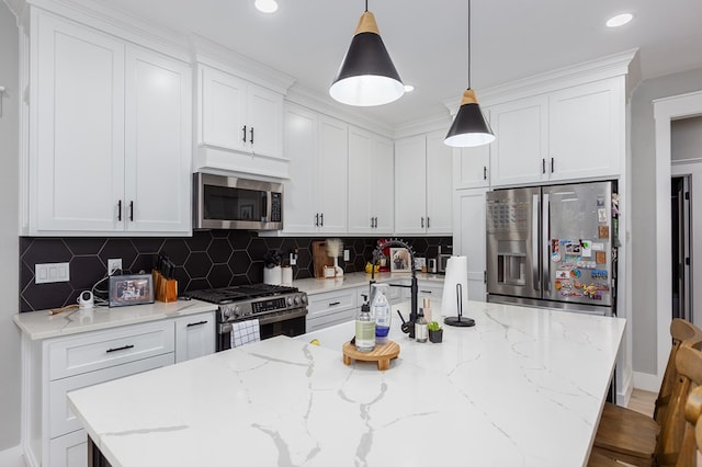 190 Whitehead Dr, Diboll, TX 75941 - kitchen with appliances with stainless steel finishes, a kitchen island with sink, white cabinets, decorative backsplash, and recessed lighting