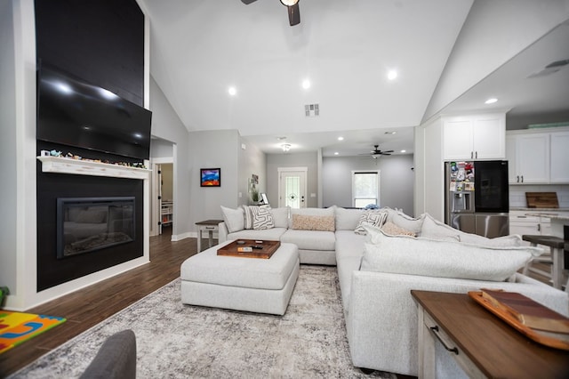 1065 Cc Rd, Diboll, TX 75941 - living room with ceiling fan, a glass covered fireplace, high vaulted ceiling, wood finished floors, and recessed lighting