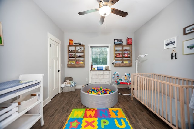 1065 Cc Rd, Diboll, TX 75941 - bedroom with a crib, wood finished floors, baseboards, and ceiling fan