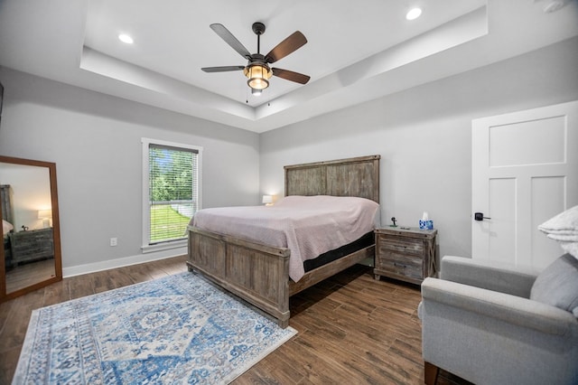 1065 Cc Rd, Diboll, TX 75941 - bedroom featuring a tray ceiling, dark wood-style floors, baseboards, recessed lighting, and a ceiling fan