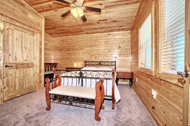 bedroom with carpet, lofted ceiling, wood ceiling, and wooden walls