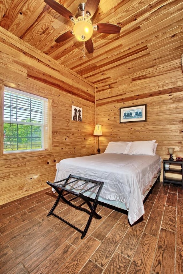 bedroom featuring dark hardwood / wood-style floors, ceiling fan, wood ceiling, and wooden walls