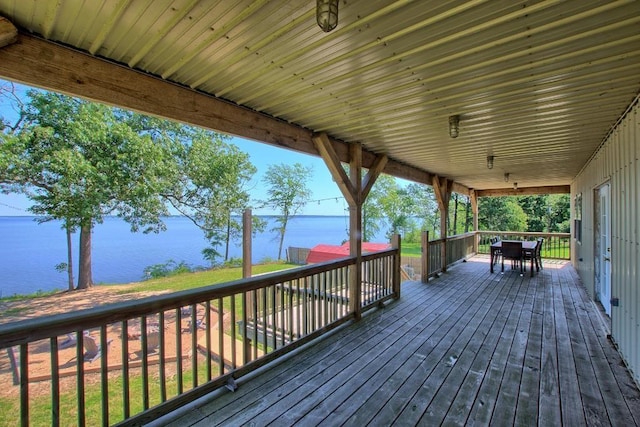 wooden terrace featuring a water view