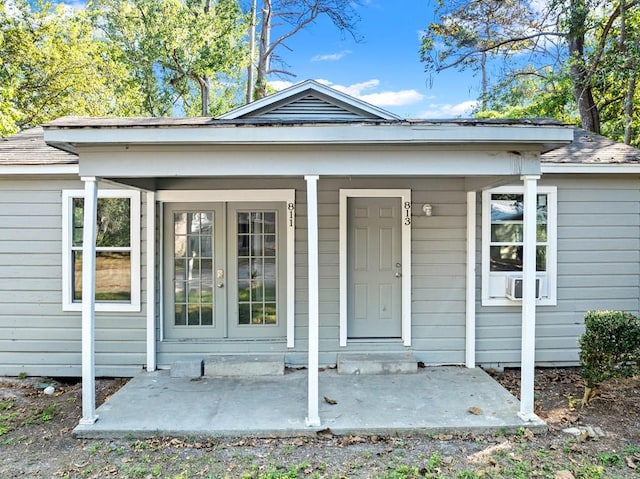 view of exterior entry with a porch