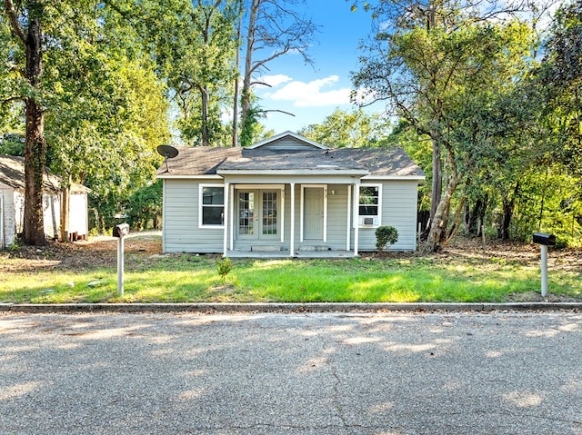 bungalow-style house with a front yard and a porch