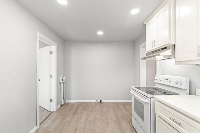 kitchen featuring electric stove, white cabinetry, and light hardwood / wood-style floors