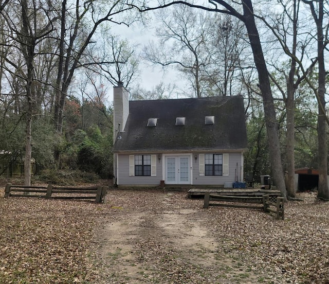 2540 Brentwood Dr, Lufkin, TX 75901 - cape cod house featuring french doors and a chimney
