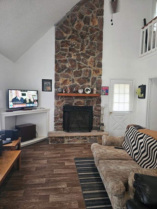 2540 Brentwood Dr, Lufkin, TX 75901 - living room featuring high vaulted ceiling, wood finished floors, a fireplace, and a textured ceiling