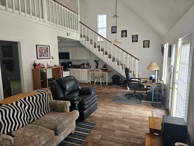 2540 Brentwood Dr, Lufkin, TX 75901 - living room featuring high vaulted ceiling, wood finished floors, stairs, and a desk
