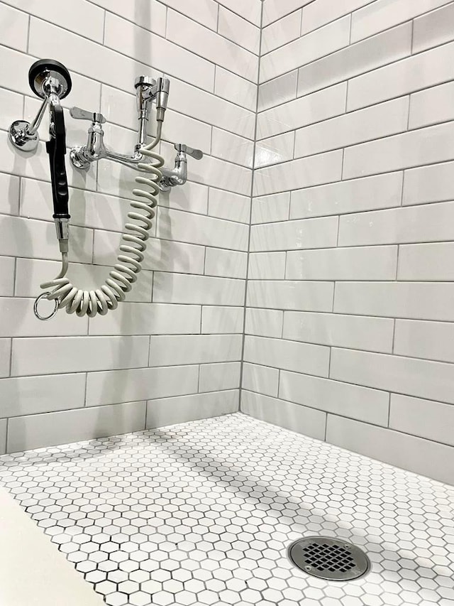 bathroom with tiled shower