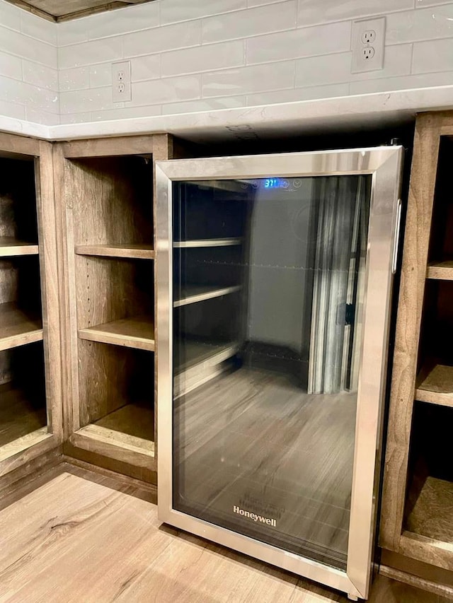 room details featuring beverage cooler and wood finished floors