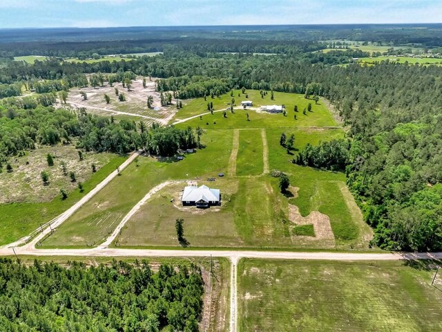 aerial view featuring a view of trees and a rural view