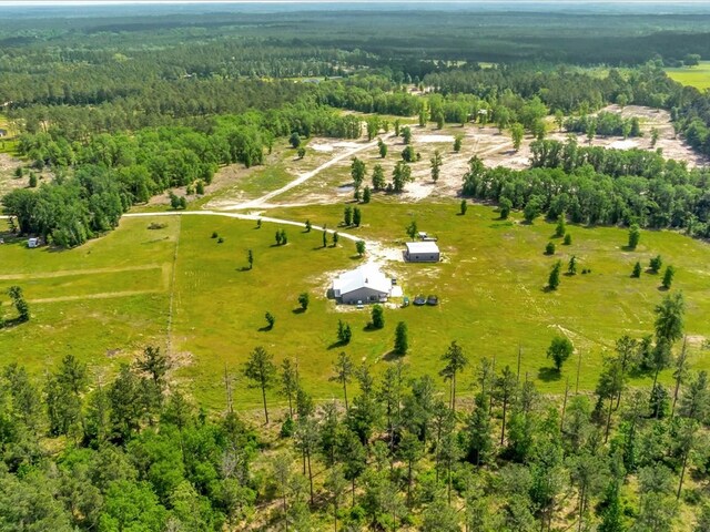 birds eye view of property featuring a rural view and a wooded view
