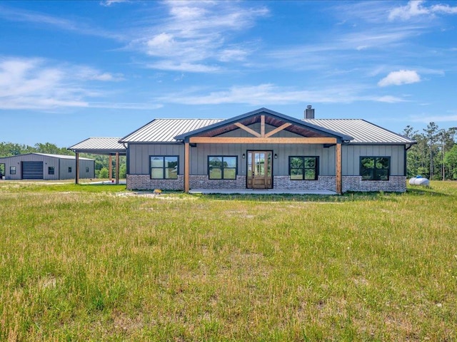 back of property featuring a standing seam roof, board and batten siding, and metal roof