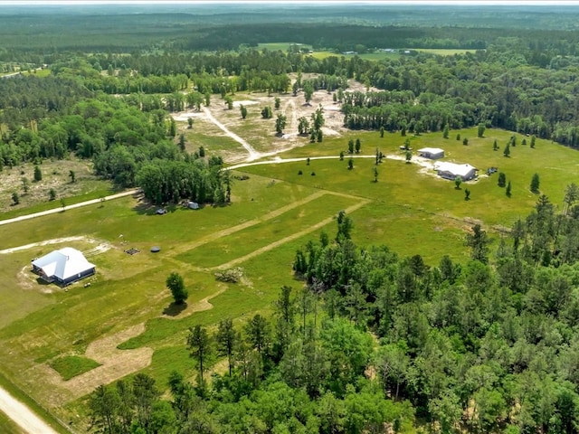 aerial view featuring a rural view and a wooded view