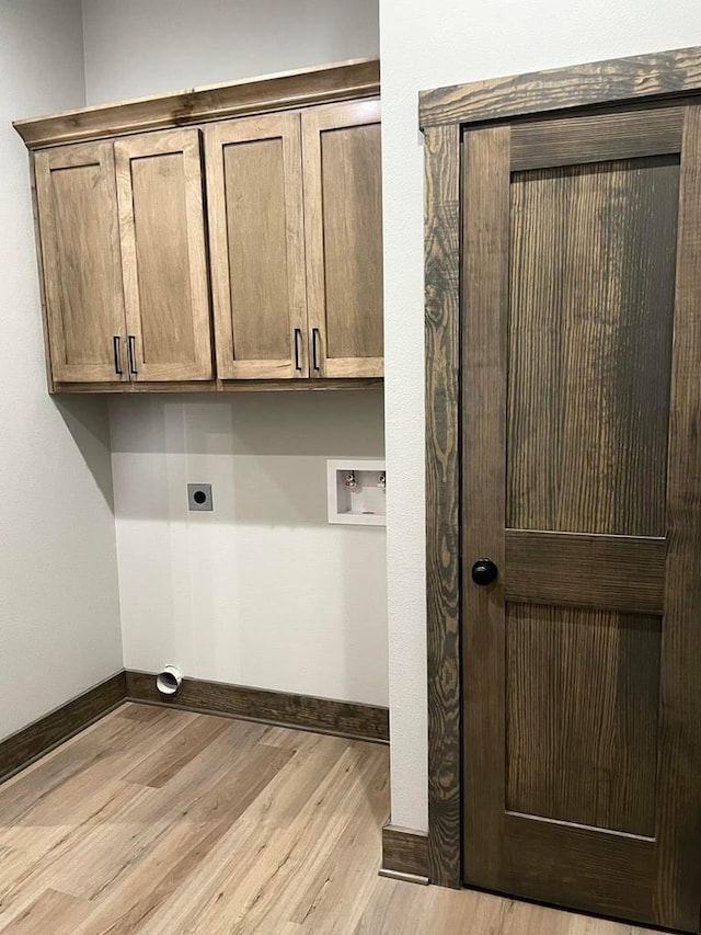 clothes washing area with light wood-style flooring, hookup for a washing machine, baseboards, and electric dryer hookup