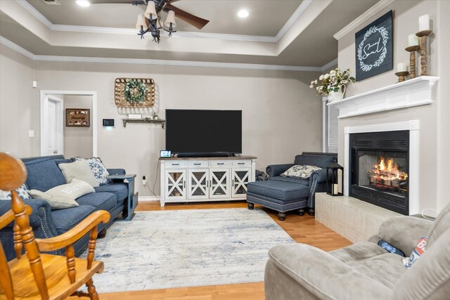 454 Bobwhite Dr, Lufkin, TX 74904 - living area with a raised ceiling, wood finished floors, a fireplace, crown molding, and ceiling fan