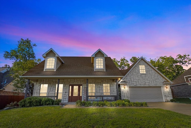 454 Bobwhite Dr, Lufkin, TX 74904 - view of front of home featuring stone siding, covered porch, concrete driveway, a yard, and an attached garage