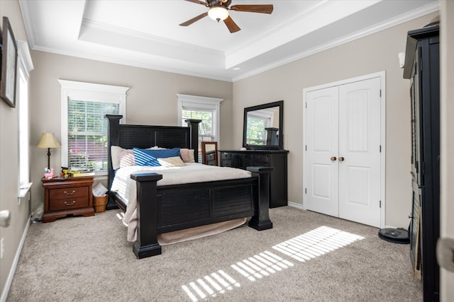 454 Bobwhite Dr, Lufkin, TX 74904 - bedroom with a raised ceiling, light carpet, ornamental molding, ceiling fan, and a closet