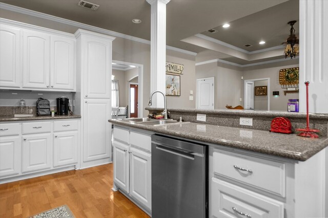 454 Bobwhite Dr, Lufkin, TX 74904 - kitchen featuring stainless steel dishwasher, decorative columns, ornamental molding, light wood-type flooring, and white cabinetry