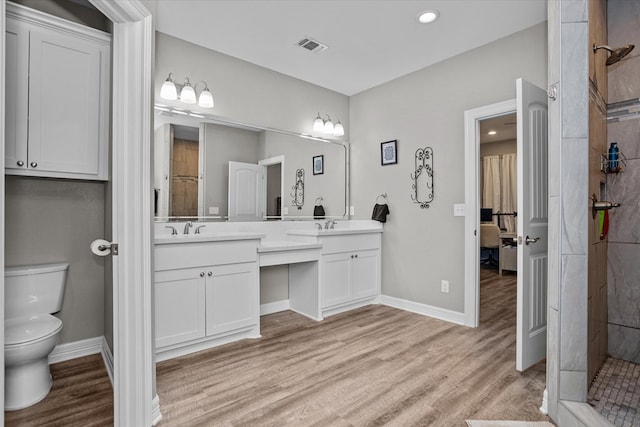 1755 Cc Rd, Diboll, TX 75941 - bathroom featuring double vanity, wood finished floors, a tile shower, and recessed lighting