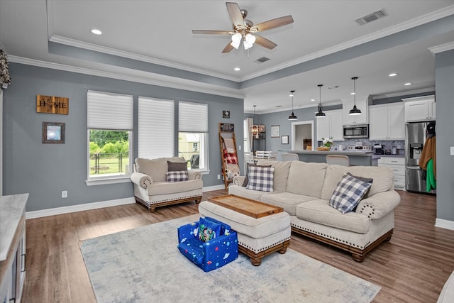 1755 Cc Rd, Diboll, TX 75941 - living area featuring ceiling fan, dark wood-type flooring, a tray ceiling, crown molding, and recessed lighting