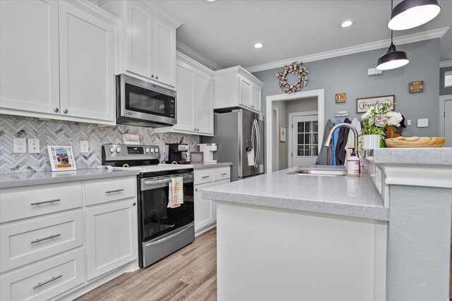 1755 Cc Rd, Diboll, TX 75941 - kitchen featuring stainless steel appliances, ornamental molding, backsplash, white cabinetry, and hanging light fixtures
