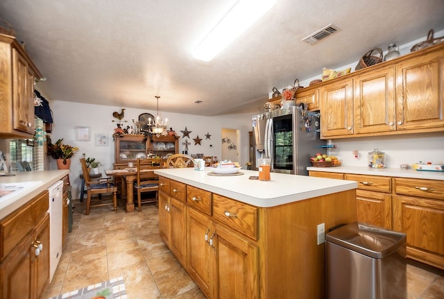 kitchen featuring dishwasher, visible vents, brown cabinets, and stainless steel fridge with ice dispenser